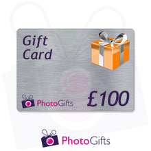 Load image into Gallery viewer, Grey £100 gift card with the writing Gift Card and Photogifts Logo as well as a picture of a gold wrapped box
