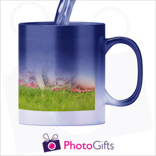 Load image into Gallery viewer, 10oz personalised blue colour change mug in its half hot stage with your own choice of image slowly being revealed as the mug heats up as produced by Photogifts.co.uk
