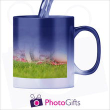 Load image into Gallery viewer, 10oz personalised blue colour change mug in its half hot stage with your own choice of image slowly being revealed as the mug heats up as produced by Photogifts.co.uk
