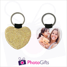 Load image into Gallery viewer, Front and back image of a heart shaped keyring. On one side the heart is all gold glitter and on the other is a photo of a mother holding a toddler and teddy bear in her arms. There is also the Photogifts Logo. Keyring as produced by Photogifts.co.uk