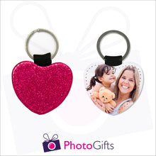 Load image into Gallery viewer, Front and back image of a heart shaped keyring. On one side the heart is all red glitter and on the other is a photo of a mother holding a toddler and teddy bear in her arms. There is also the Photogifts Logo. Keyring as produced by Photogifts.co.uk