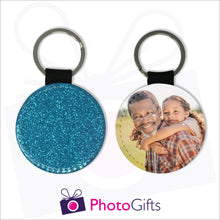 Load image into Gallery viewer, Two sides of a round keyring. On one side is a blue glitter covering the whole keyring and on the other side is a picture of a grandfather giving his granddaughter a piggy back in a field. Keyring as produced by Photogifts.co.uk
