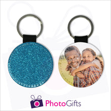 Load image into Gallery viewer, Two sides of a round keyring. On one side is a blue glitter covering the whole keyring and on the other side is a picture of a grandfather giving his granddaughter a piggy back in a field. Keyring as produced by Photogifts.co.uk