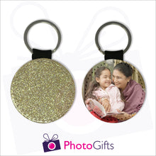 Load image into Gallery viewer, Two sides of a round keyring. On one side is a gold glitter covering the whole keyring and on the other side is a picture of a grandmother sitting next to her granddaughter reading a book together with some creamy brown curtains in the background. Keyring as produced by Photogifts.co.uk