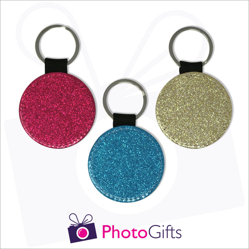 Three glitter round keyrings. Each keyring is a single coloured glitter in either red, blue or gold. Also shown is the Photogifts logo. Keyring as produced by Photogifts.co.uk
