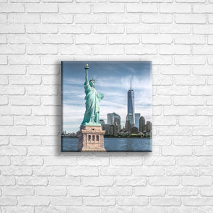 Personalised 12x12" square wrapped canvas with your own choice of image hung on a white brick wall by Photogifts.co.uk
