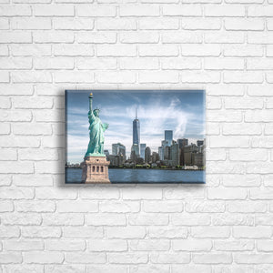 Personalised 12x8" Landscape wrapped canvas with your own choice of image hung on a white brick wall by Photogifts.co.uk