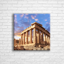 Load image into Gallery viewer, Personalised 16x16" square border canvas with your own choice of image hung on a white brick wall by Photogifts.co.uk