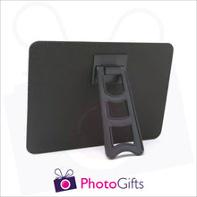 Load image into Gallery viewer, Rear view of faux leather customised photo panel 182mm x 132mm (7" x 5") in landscape orientation. Picture details show plastic easel stand on back of the panel
