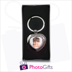 Personalised heart shaped metal pendant keyring with rhinestone detailing and your own choice of image in the centre. Keyring is displayed in a box as produced by Photogifts.co.uk