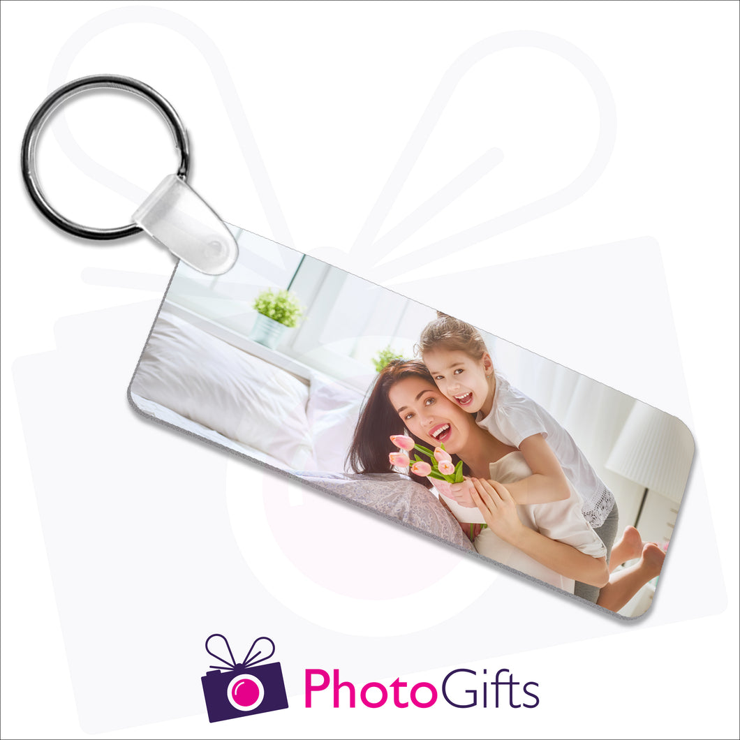 Double sided plastic keyring in a rectangular shape with your own choice of image on both sides as produced by Photogifts.co.uk