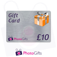 Load image into Gallery viewer, Grey £10 gift card with the writing Gift Card and Photogifts Logo as well as a picture of a gold wrapped box
