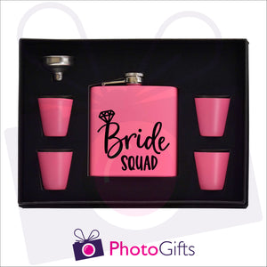 Open boxed gift set of a pink hip flask with silver funnel and four matching shot glasses. Hip flask has the words Bride Squad personalised on the flask. Flask set as produced by Photogifts.co.uk