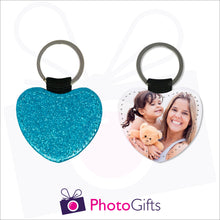 Load image into Gallery viewer, Front and back image of a heart shaped keyring. On one side the heart is all blue glitter and on the other is a photo of a mother holding a toddler and teddy bear in her arms. There is also the Photogifts Logo. Keyring as produced by Photogifts.co.uk
