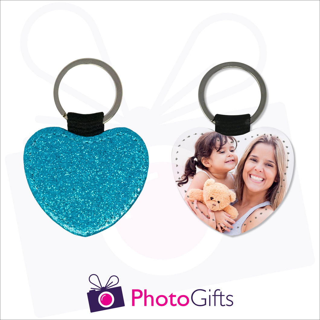 Front and back image of a heart shaped keyring. On one side the heart is all blue glitter and on the other is a photo of a mother holding a toddler and teddy bear in her arms. There is also the Photogifts Logo. Keyring as produced by Photogifts.co.uk