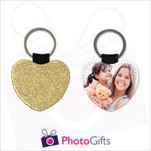 Load image into Gallery viewer, Front and back image of a heart shaped keyring. On one side the heart is all gold glitter and on the other is a photo of a mother holding a toddler and teddy bear in her arms. There is also the Photogifts Logo. Keyring as produced by Photogifts.co.uk
