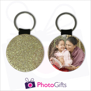 Two sides of a round keyring. On one side is a gold glitter covering the whole keyring and on the other side is a picture of a grandmother sitting next to her granddaughter reading a book together with some creamy brown curtains in the background. Keyring as produced by Photogifts.co.uk