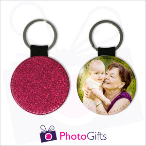Two sides of a round keyring. On one side is a red glitter covering the whole keyring and on the other side is a picture of a grandmother holding a baby up to her face with some green trees blurred in the background. Keyring as produced by Photogifts.co.uk