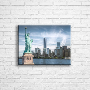 Personalised 16x12" Landscape wrapped canvas with your own choice of image hung on a white brick wall by Photogifts.co.uk