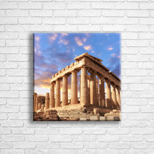 Load image into Gallery viewer, Personalised 16x16&quot; square border canvas with your own choice of image hung on a white brick wall by Photogifts.co.uk
