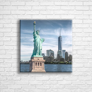 Personalised 16x16" square wrapped canvas with your own choice of image hung on a white brick wall by Photogifts.co.uk
