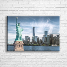 Load image into Gallery viewer, Personalised 24x16&quot; landscape wrapped canvas with your own choice of image hung on a white brick wall by Photogifts.co.uk
