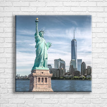 Load image into Gallery viewer, Personalised 24x24&quot; square wrapped canvas with your own choice of image hung on a white brick wall by Photogifts.co.uk
