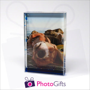 152mm x 102mm (6" x 4") clear acrylic freestanding block, in portrait orientation,  that can be personalised with your own choice of image. The block is filled with some blue gel suspended within a clear liquid. The chosen image is clipped to the back of the block and shows through so you can see it behind the liquid. When the block is shaken the blue gel will slowly make its way down to the bottom of the block similar to a snow globe