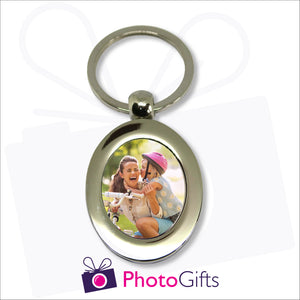 Metal pendant keyring in the shape of an oval with your own image in the centre of the keyring as produced by Photogifts.co.uk